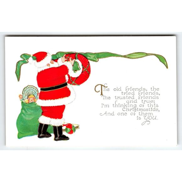 Vintage Christmas Postcard Santa Claus Hanging A Wreath & Baby Doll Antique - Picture 1 of 2
